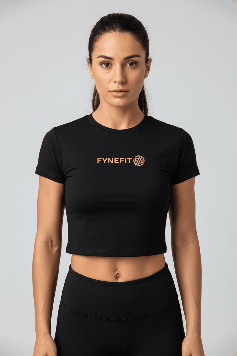 Black women's performance crop T-shirt by FyneFIT with a chest logo, featuring a fitted style and short sleeves.