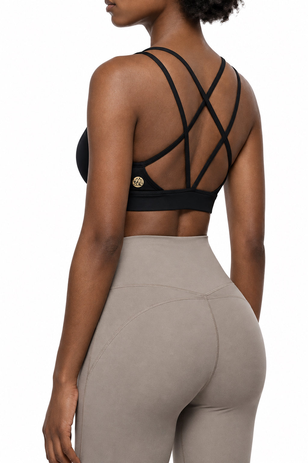 Rear view of a woman wearing a black sports bra with crisscross back straps 
