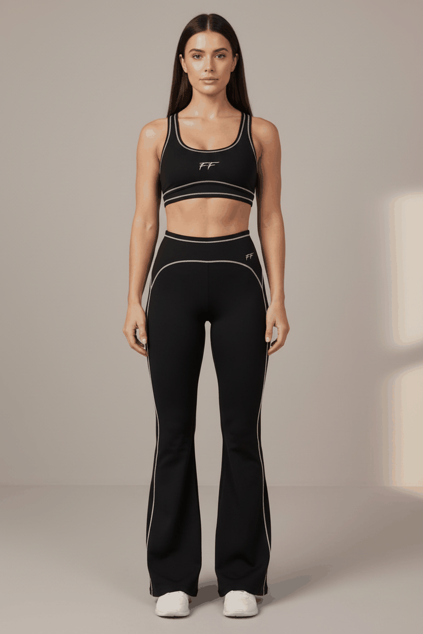 Women’s Double Take High Rise black flared yoga pants with white seam accents and a fitted silhouette.