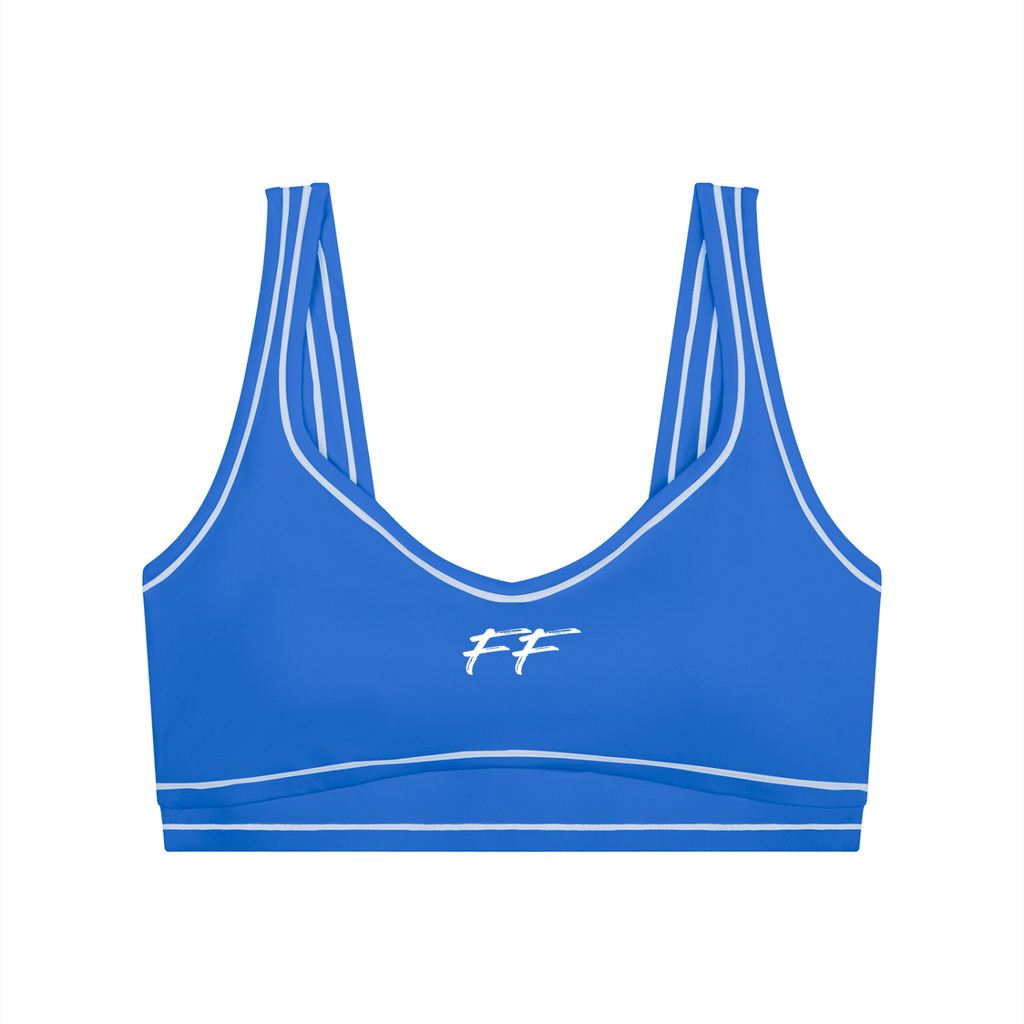 Blue nylon blend sports bra with white contrast seams, U-neckline, and elastic hem featuring Double Take Topstitching details.