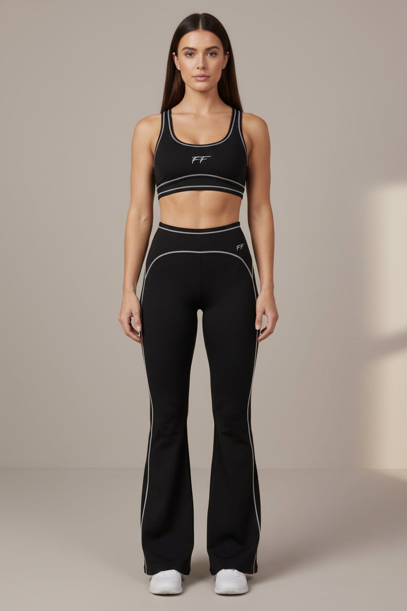 ODMPOD Double Take high rise flared yoga pants shown in black, featuring a fitted waistband and flared leg design.