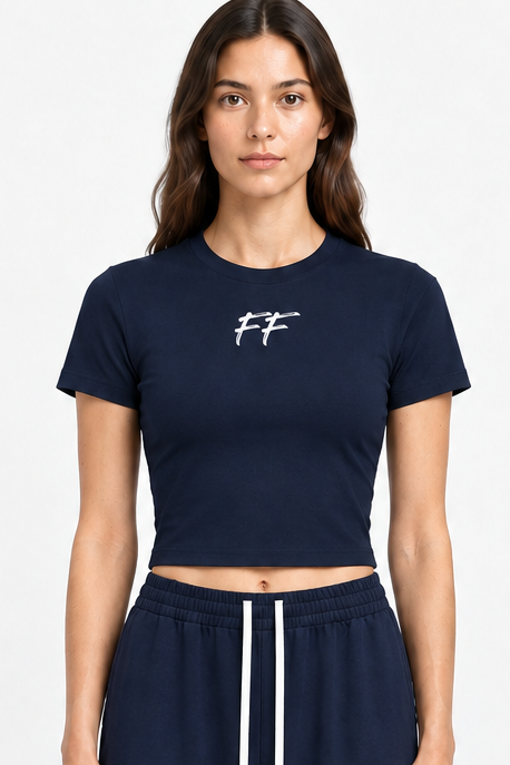 Model wearing ODMPOD FF Varsity Club Performance Crop T-Shirt in navy, showcasing the fitted design and stylish athletic look.